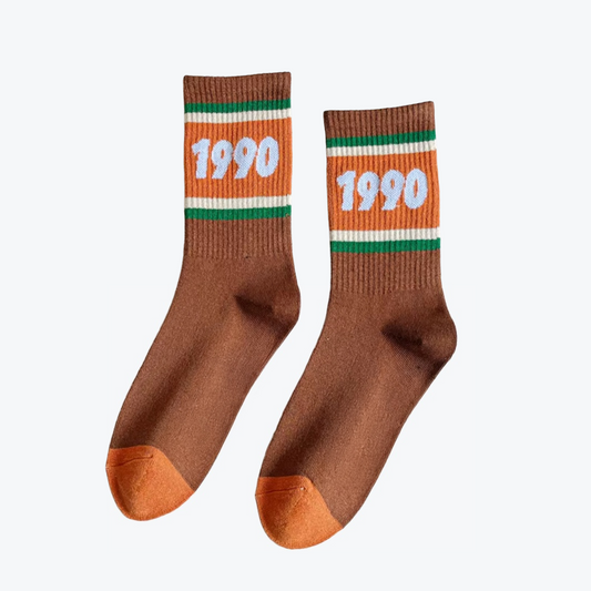 Brown socks with '1990' print on an orange band against a white background