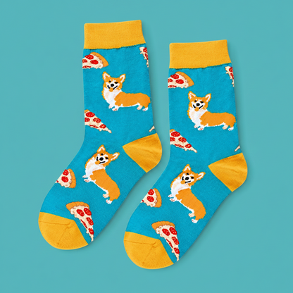A pair of crew socks with a bright blue background featuring cartoon Corgi dogs and pizza slices, with yellow cuffs, heels, and toes, displayed on a clean white background.