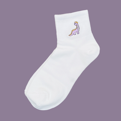 White sock with a small embroidered design on a purple background