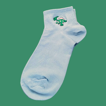Light blue sock with a green dinosaur design on a transparent background