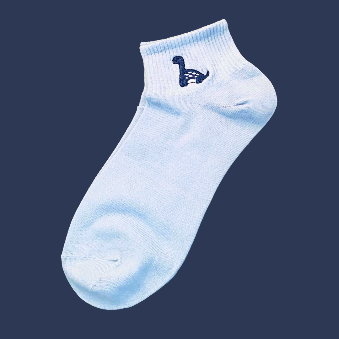 Light blue ankle sock with a small logo on a dark blue background