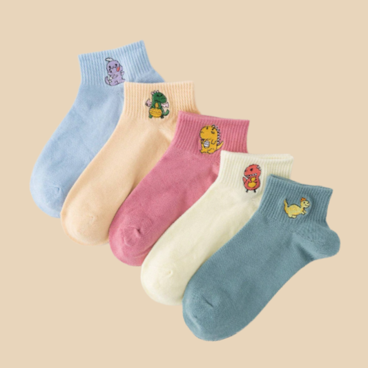 Five pairs of colorful socks with cartoon character designs on a beige background