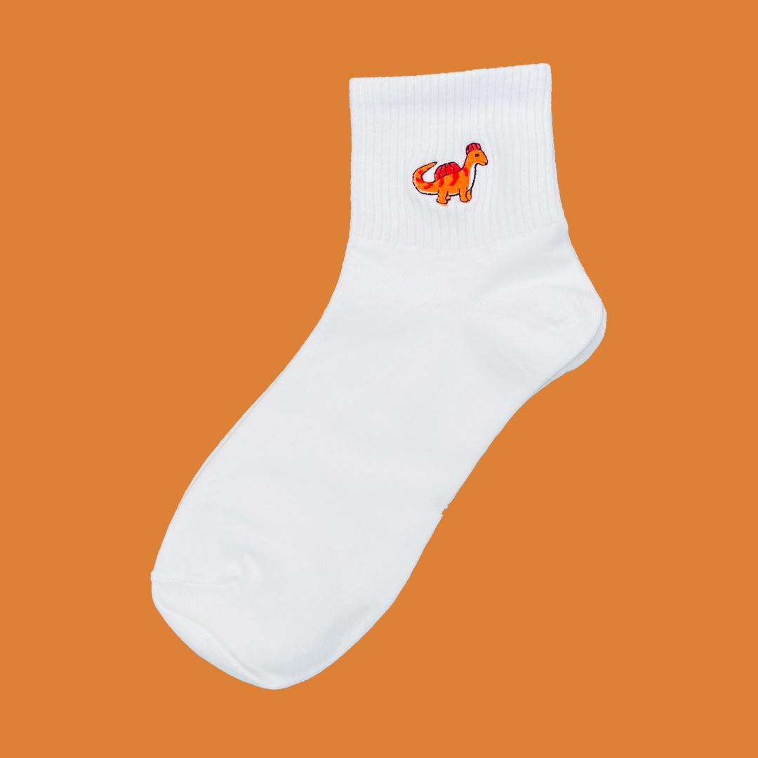 White sock with a colorful dog design on an orange background