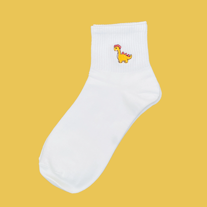 White sock with a colorful dinosaur design on a yellow background