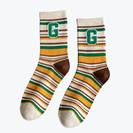 Pair of striped socks with letter 'G' on a white background