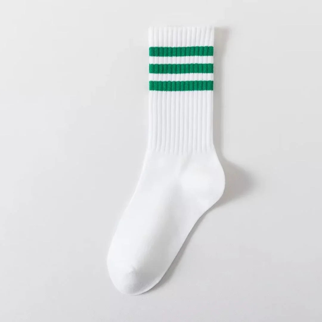 White crew sock with three green stripes at the top, flat lay on white background