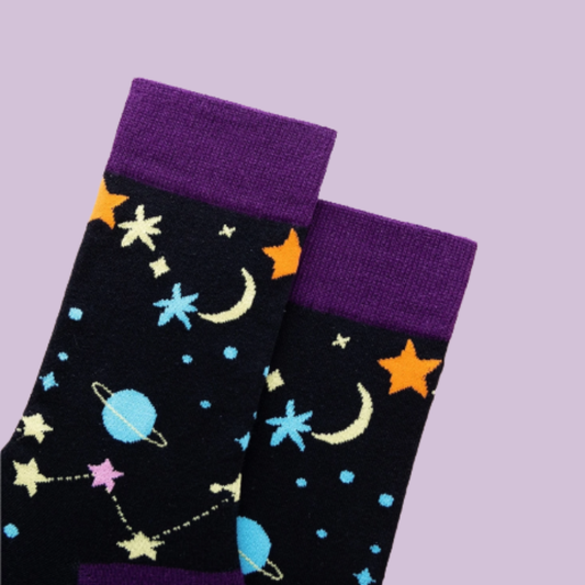 Black socks with space-themed designs on a purple background