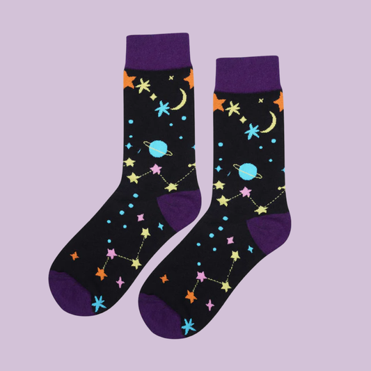 Pair of socks with space-themed design on a light purple background