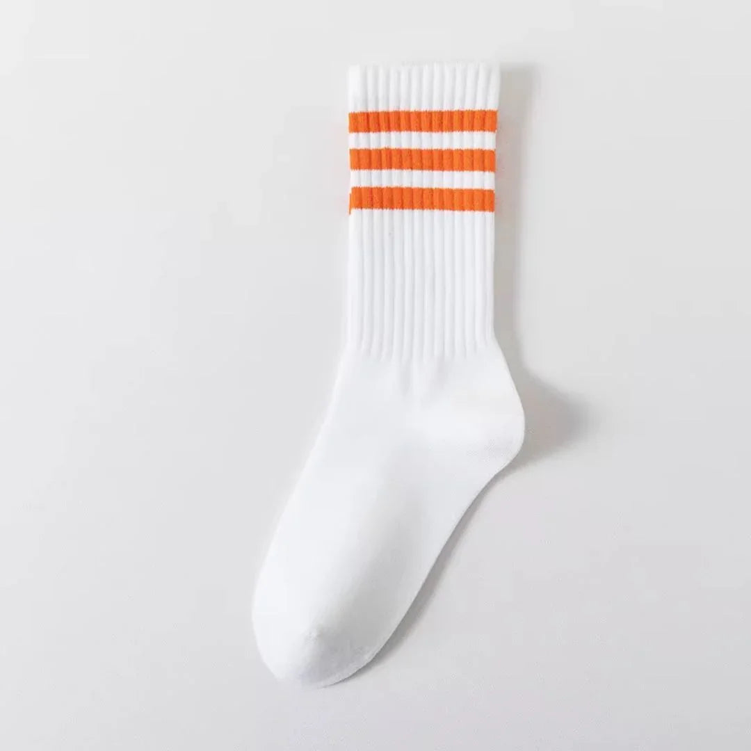 White crew sock with three orange stripes at the cuff, ribbed texture, on a plain white background