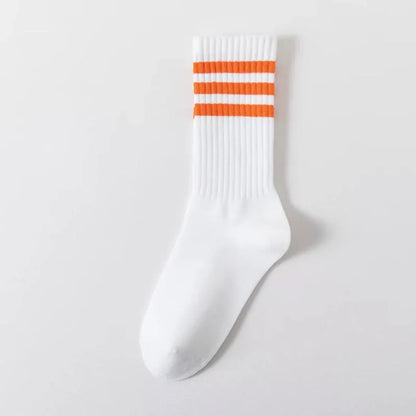 White crew sock with three orange stripes at the cuff, ribbed texture, on a plain white background