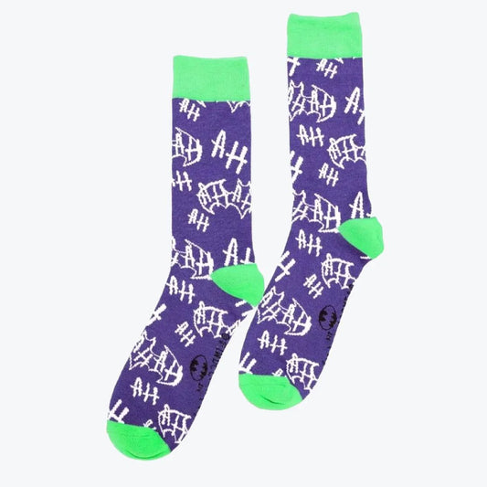 Pair of purple joker socks with white text and green cuffs and toes