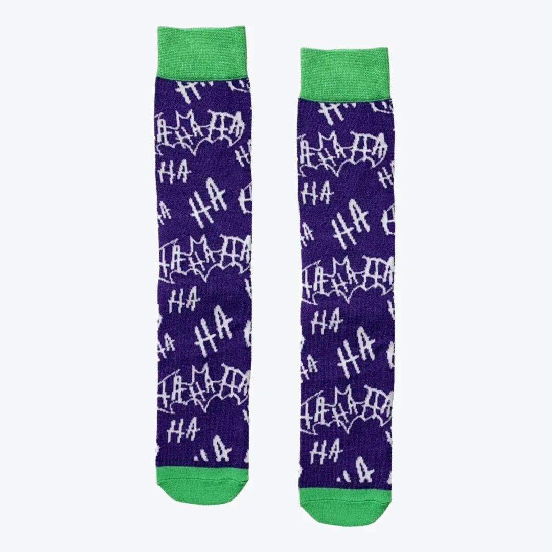 Pair of purple socks with white text and green cuffs and toes