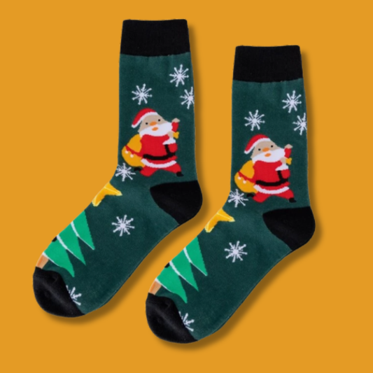 Pair of festive socks with Santa Claus design on a yellow background