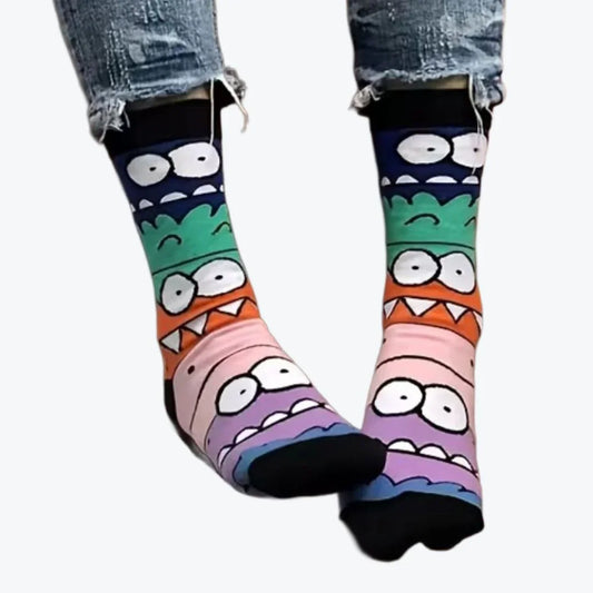 Colorful cartoon monster socks with eyes and teeth worn with ripped blue jeans