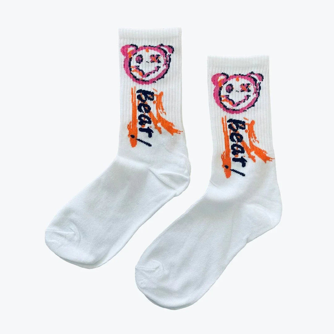 White socks with colorful bear design and text 