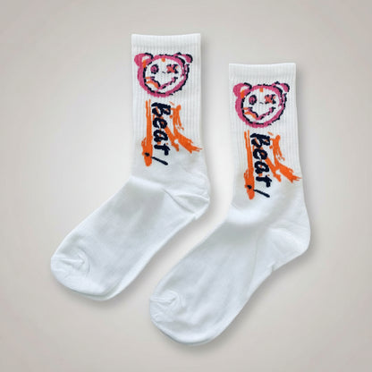 White socks with colorful bear design and text 