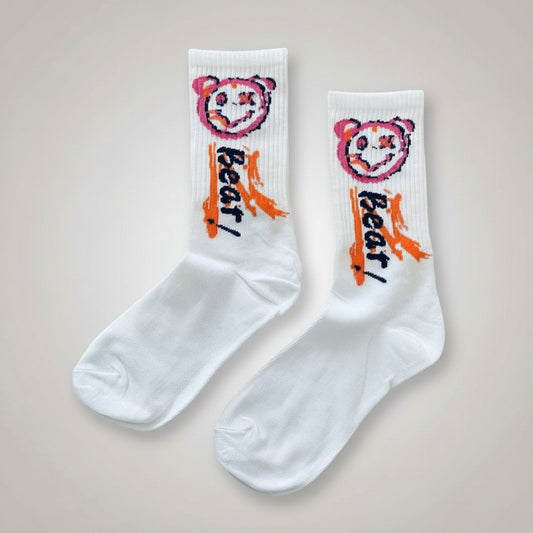 White socks with colorful bear design and text 