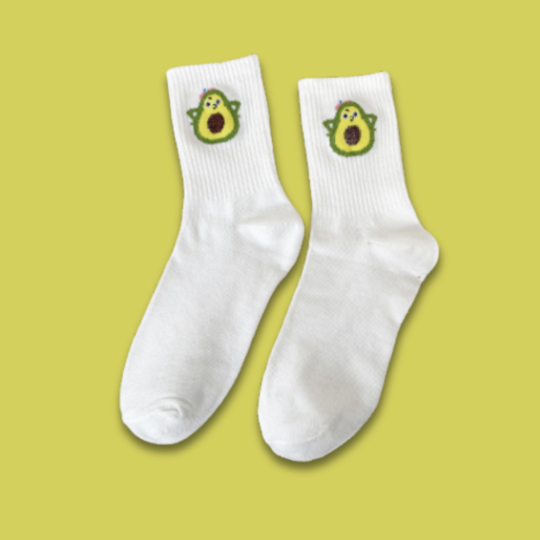 White socks with avocado designs on a yellow background