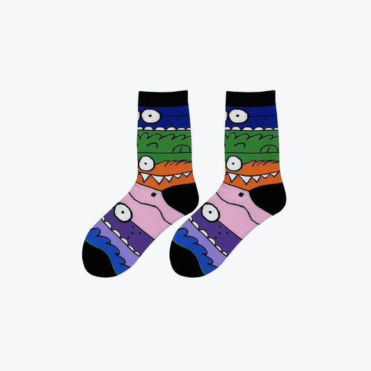 Colorful socks with cartoonish monster faces on a white background