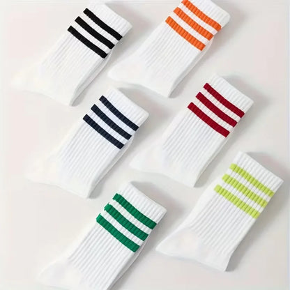 Set of white socks with colorful stripes on a light background